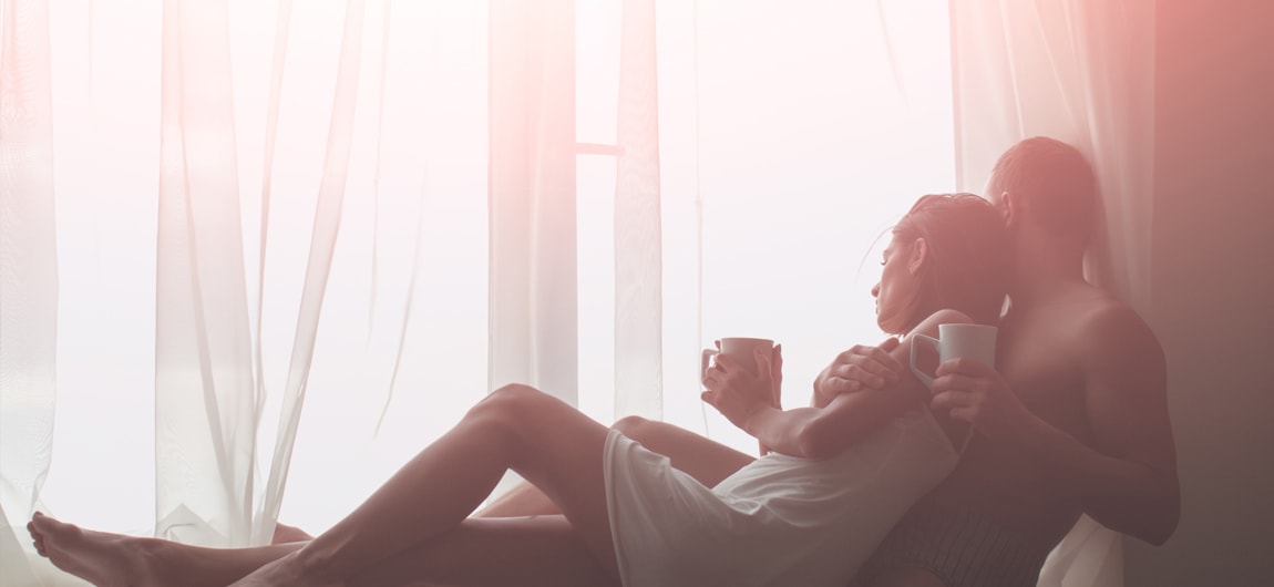 Morning sunrise viewed through motorised blinds on a schedule