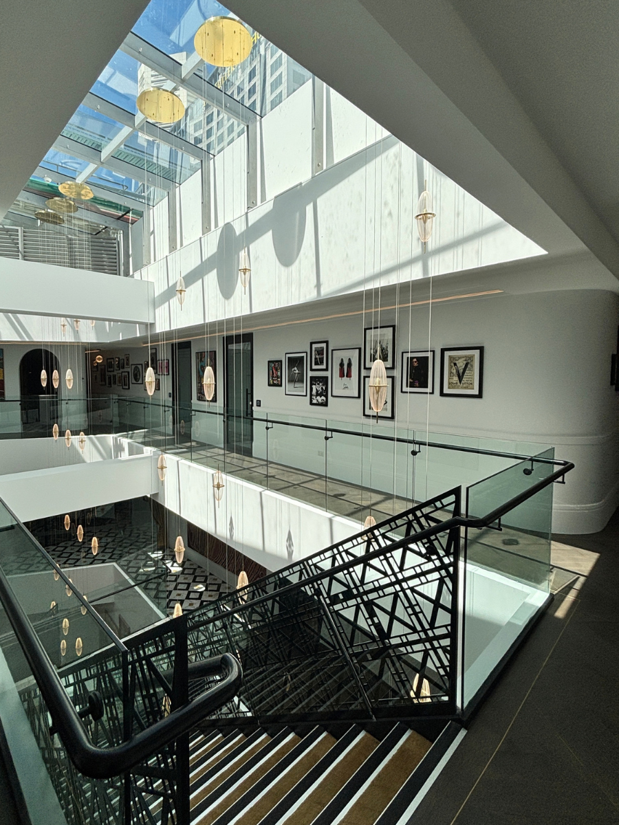 Light-filled atrium with gallery wall and stair